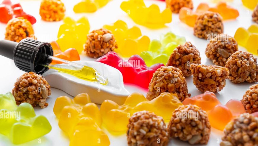 gummy-bears-cbd-cookies-and-thd-oil-dropper-in-white-backdrop-thd-or-cannabis-sweets-in-form-of-gelatine-gummi-bears-and-essential-oil-pipette-backg-2EW62FE